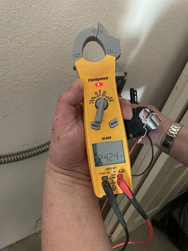 Voltage testing with clamp meter during Whole House Surge Protector in Chattahoochee Hills